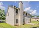 Exterior view of the home with a grassy backyard and a concrete patio at 4938 Wewatta Sw St, Atlanta, GA 30331
