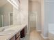 Bright bathroom features a double sink vanity, large mirror, and a walk-in closet at 4938 Wewatta Sw St, Atlanta, GA 30331