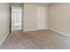 Bedroom featuring neutral walls, carpeting and a door, offering a calming space at 4938 Wewatta Sw St, Atlanta, GA 30331