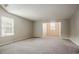 Large room with neutral walls, vaulted ceiling, carpeting, and windows with natural light at 4938 Wewatta Sw St, Atlanta, GA 30331