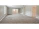 Large room featuring neutral walls and carpeting, with a door leading to another room at 4938 Wewatta Sw St, Atlanta, GA 30331