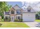 Two-story home featuring a stone facade and manicured lawn at 4938 Wewatta Sw St, Atlanta, GA 30331