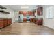 Spacious kitchen with stainless steel appliances and modern wood floor at 4938 Wewatta Sw St, Atlanta, GA 30331