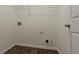 Spacious laundry room with wood look floors and utility connections at 4938 Wewatta Sw St, Atlanta, GA 30331