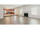 Open-concept living space featuring a fireplace and wood flooring at 4938 Wewatta Sw St, Atlanta, GA 30331