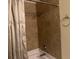 Bathroom shower with tan tile, a shower curtain, and a towel hook at 750 Providence Dr, Lawrenceville, GA 30044