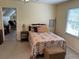 Cozy bedroom with a colorful bed, window, and a doorway to an adjoining room at 750 Providence Dr, Lawrenceville, GA 30044