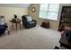 Spacious bonus room with a comfy recliner, natural light, and a bookcase at 750 Providence Dr, Lawrenceville, GA 30044