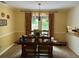 Dining room featuring a chandelier, hardwood floors, and door to backyard at 750 Providence Dr, Lawrenceville, GA 30044