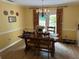 Dining room featuring a chandelier, hardwood floors, and door to backyard at 750 Providence Dr, Lawrenceville, GA 30044