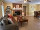 Comfortable living room features a brick fireplace, ceiling fan, and hardwood flooring at 750 Providence Dr, Lawrenceville, GA 30044