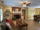 Comfortable living room features a brick fireplace, ceiling fan, and hardwood flooring at 750 Providence Dr, Lawrenceville, GA 30044