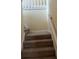 Carpeted staircase with a white handrail at 750 Providence Dr, Lawrenceville, GA 30044
