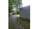 View of the backyard and a shed, with a paved driveway and some trees at 1095 S Burnt Hickory Rd, Douglasville, GA 30134