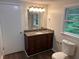 Bathroom featuring a single sink vanity with granite countertop, updated fixtures, and toilet at 1095 S Burnt Hickory Rd, Douglasville, GA 30134