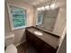 Bathroom with dark wood vanity, granite countertop, and a large mirror with modern lighting at 1095 S Burnt Hickory Rd, Douglasville, GA 30134