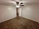 This bedroom features neutral walls, a ceiling fan with lights, and cozy brown carpeting at 1095 S Burnt Hickory Rd, Douglasville, GA 30134