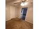 This bedroom features neutral walls, a closet, a ceiling fan, and comfortable brown carpet at 1095 S Burnt Hickory Rd, Douglasville, GA 30134