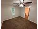Bedroom featuring neutral walls, brown carpet, a ceiling fan with lights, and one window at 1095 S Burnt Hickory Rd, Douglasville, GA 30134
