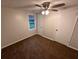 This bedroom features neutral walls, a ceiling fan, brown carpet, and one window for natural light at 1095 S Burnt Hickory Rd, Douglasville, GA 30134