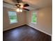 This bedroom features neutral walls, wood-look flooring, and two windows for natural light at 1095 S Burnt Hickory Rd, Douglasville, GA 30134