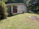 Cozy single-story home featuring a quaint porch and lush green lawn surrounded by mature trees at 1095 S Burnt Hickory Rd, Douglasville, GA 30134