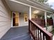 Inviting front porch with painted floors, white columns, and a dark stained railing at 1095 S Burnt Hickory Rd, Douglasville, GA 30134