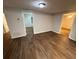 Open-concept living room offers wood-look floors and ample natural light with views of other rooms at 1095 S Burnt Hickory Rd, Douglasville, GA 30134