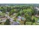Aerial view showing a home with a pool surrounded by mature trees in a quiet neighborhood at 229 Primstone Way, Mcdonough, GA 30253