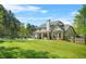 Expansive backyard featuring a well-maintained lawn, covered patio, and a sparkling pool, perfect for outdoor entertaining at 229 Primstone Way, Mcdonough, GA 30253