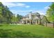 Expansive backyard with a swimming pool, lush lawn, and a private, wooded perimeter at 229 Primstone Way, Mcdonough, GA 30253