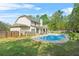 Large backyard featuring a sparkling pool, well-manicured lawn, and cozy outdoor seating at 229 Primstone Way, Mcdonough, GA 30253