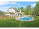Large backyard featuring a sparkling pool, well-manicured lawn, and cozy outdoor seating at 229 Primstone Way, Mcdonough, GA 30253