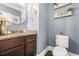 Stylish half bathroom features elegant granite countertops, decorative accents, and modern fixtures for guests at 229 Primstone Way, Mcdonough, GA 30253