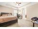 Comfortable bedroom with tray ceilings, a ceiling fan and space for a computer desk and gaming chair at 229 Primstone Way, Mcdonough, GA 30253