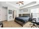 Inviting bedroom offers light-blue walls, a tray ceiling with ceiling fan and work space with gaming chair at 229 Primstone Way, Mcdonough, GA 30253