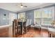 Bright dining area with hardwood floors, featuring a dining table set near large windows at 229 Primstone Way, Mcdonough, GA 30253