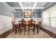 Formal dining room featuring coffered ceilings, wainscoting, chandelier, and a large window at 229 Primstone Way, Mcdonough, GA 30253