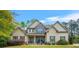 Attractive home with stone accents, complemented by a lush front yard and manicured landscaping at 229 Primstone Way, Mcdonough, GA 30253
