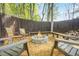Outdoor fire pit with seating, perfect for entertaining or enjoying cozy evenings in a fenced backyard at 229 Primstone Way, Mcdonough, GA 30253