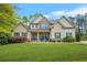 Charming two-story home with a well-manicured lawn, stone accents, and inviting front porch at 229 Primstone Way, Mcdonough, GA 30253