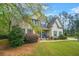 Charming two-story home with a well-manicured lawn, stone accents, and inviting front porch with blue chairs at 229 Primstone Way, Mcdonough, GA 30253