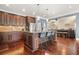 Stylish kitchen featuring dark wood cabinets, granite countertops, and a large center island at 229 Primstone Way, Mcdonough, GA 30253