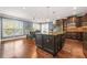 Spacious kitchen with a large island, dark wood cabinets, and stainless steel appliances at 229 Primstone Way, Mcdonough, GA 30253