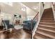 Bright living room with fireplace, TV, large windows, and open access to the dining area at 229 Primstone Way, Mcdonough, GA 30253