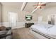 Relax in this primary suite that features a tray ceiling, ceiling fan, and wall-mounted TV above an entertainment center at 229 Primstone Way, Mcdonough, GA 30253
