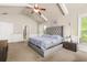 Bright main bedroom features vaulted ceiling with ceiling fan and a tufted headboard bed frame at 229 Primstone Way, Mcdonough, GA 30253