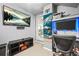 Modern office space with a large TV, ample desk space, and natural light at 229 Primstone Way, Mcdonough, GA 30253