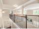 View of the hallway on an upper level with railings, arched doorways and natural light at 229 Primstone Way, Mcdonough, GA 30253