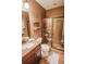 Bathroom with a granite vanity, glass shower, and tile floors and walls at 440 Canton Walk, Roswell, GA 30075